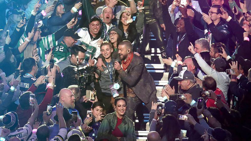 Justin Timberlake (C) performs onstage during the Pepsi Super Bowl LII Halftime Show at U.S. Bank Stadium on February 4, 2018 in Minneapolis, Minnesota.  Ryan McKenna (L), 13, became a viral sensation after snapping a selfie with him during the show.