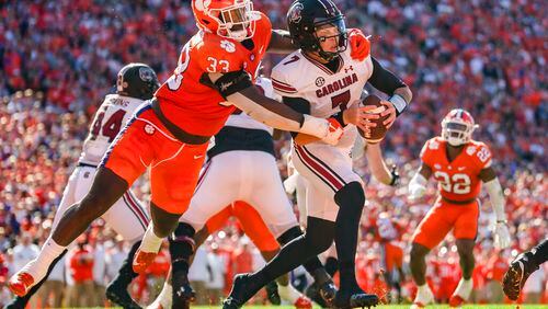 Clemson defensive tackle Ruke Orhorhoro (33) sacks South Carolina quarterback Spencer Rattler (7) for a safety in the first half of an NCAA college football game on Saturday, Nov. 26, 2022, in Clemson, S.C. (AP Photo/Jacob Kupferman)