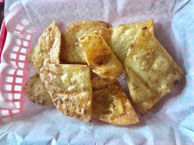 The sopapillas (fried pastry puffs) prepared at Ronaldo’s Resto Bar are crispy and cracker-like, and with a dusting of cinnamon-sugar and a drizzle of honey. LIGAYA FIGUERAS / LFIGUERAS@AJC.COM