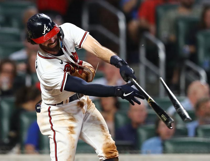 Braves shortstop Dansby Swanson shatters his bat on an RBI single to take a 9-1 lead over the Philadelphia Phillies during the fifth inning of a MLB baseball game on Tuesday, August 2, 2022, in Atlanta.   “Curtis Compton / Curtis Compton@ajc.com