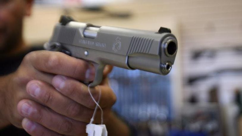 A man purchases a gun at a store in Glendale California. AFP PHOTO/GABRIEL BOUYS