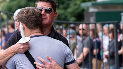 210801-Atlanta-Chip Powell hugs Andrew Hoekstra before a vigil for Midtown stabbing victim Katie Janness on Sunday evening, August 1, 2021 at Piedmont Park. Ben Gray for the Atlanta Journal-Constitution