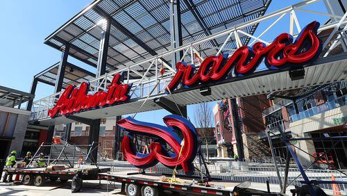 The Braves, like their new stadium, are still under construction. Here, workers prepare to install the B on a Braves sign across a pedestrian bridge into the team’s new stadium, SunTrust Park. (Curtis Compton/ccompton@ajc.com)