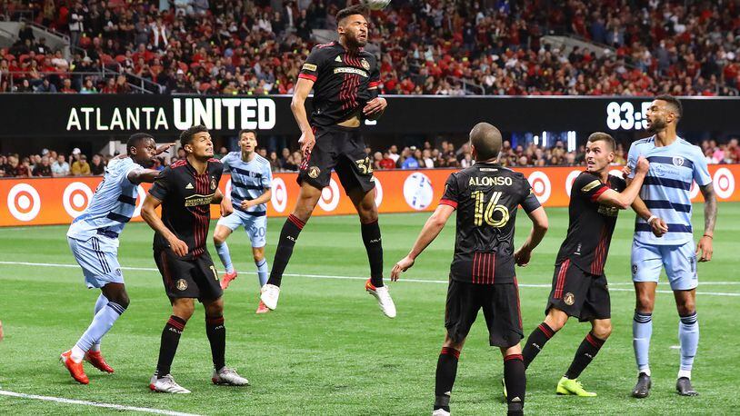 022722 : Atlanta United defender George Campbell clears a kick on goal away from the front of the net to hold onto a 3-1 victory overt Sporting KC in a MLS soccer match on Sunday, Feb. 27, 2022, in Atlanta.  “Curtis Compton / Curtis.Compton@ajc.com”`
