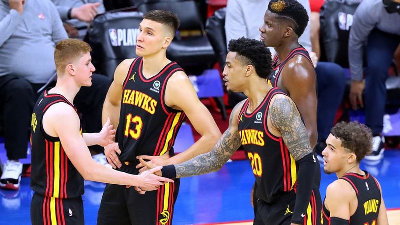 Hawks players Kevin Huerter (from left), Bogan Bogdanovic, John Collins, Clint Capela and Trae Young confer during a break of the 128-124 win over the 76ers in Game 1 of the conference semifinals Sunday, June 7, 2021, in Philadelphia. (Curtis Compton/Curtis.Compton@ajc.com)
