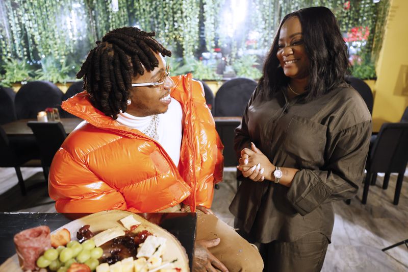 R&B singer Jacquees (left) talks with his business partner Voneka Marks at The Wine and Tapas Lounge, located in Stonecrest; the new restaurant offers a family atmosphere and a place to relax. Miguel Martinez / miguel.martinezjimenez@ajc.com