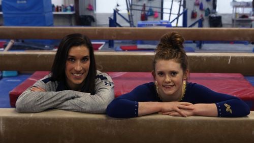 Sienna Schreiber (right) poses for a portrait with her gymnastics coach at West Forsyth High School, Ashley Owen (left), at the Northwind Gymnastics Center in Alpharetta on May 4, 2017. Sienna is a level-10 gymnast and placed first overall in the Georgia High School Association’s state championship with a score of 39.194. While only a sophomore, she has secured a scholarship to the University of Missouri for gymnastics. (HENRY TAYLOR / HENRY.TAYLOR@AJC.COM)