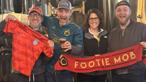 Employees at Wild Heaven Beer, a sponsor of Atlanta United and members of the unofficial Footie Mob that supports soccer in Atlanta, celebrate the announcement that Atlanta will host eight games of the 2026 Wold Cup. The are, from the left Brian Deutsch, Nick Purdy, Emily Markette and Davis Roberts. Photo: Wild Heaven