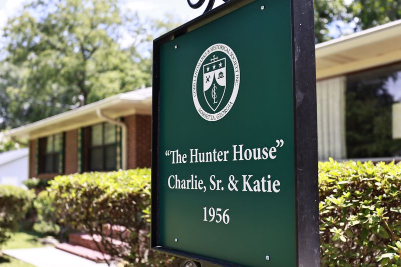 Views of the home marker in front of the house of prominent businessman Charlie Hunter Sr. on Friday, July 29, 2022. The house is the first in a historic Black neighborhood to receive a home marker. (Natrice Miller/natrice.miller@ajc.com)