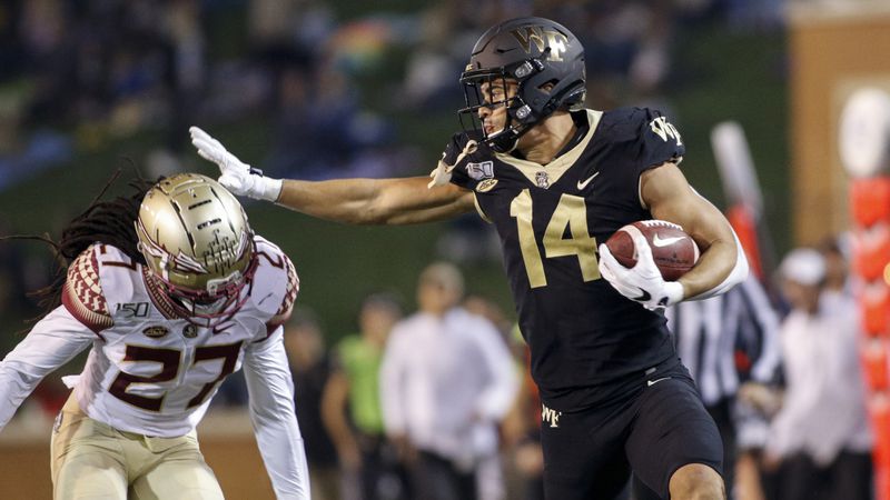 Wake Forest wide receiver Sage Surratt (right) stiff arms Florida State defensive back Akeem Dent after a catch in the first half Saturday, Oct. 19, 2019, in Winston-Salem, N.C. (Nell Redmond/AP)