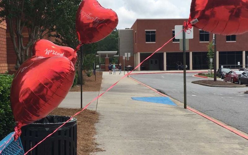 Four red heart balloons sway outside Harrison High School the first day of school after Joelle Dalgleish died in a camping accident.