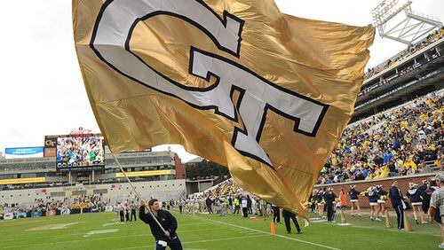 Atlanta: A Georgia Tech cheerleader waves the giant GT flag after a Georgia Tech touchdown in Bobby Dodd Stadium on Saturday, October 19, 2013. AJC file photo by Johnny Crawford