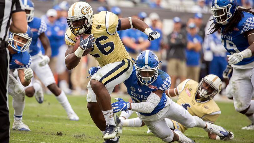 Georgia Tech running back Dedrick Mills (26) is tackled by Kentucky safety Mike Edwards (27) during the second half of the TaxSlayer Bowl NCAA college football game, Saturday, Dec. 31, 2016, in Jacksonville, Fla. Georgia Tech beat Kentucky 33-18. (AP Photo/Stephen B. Morton)