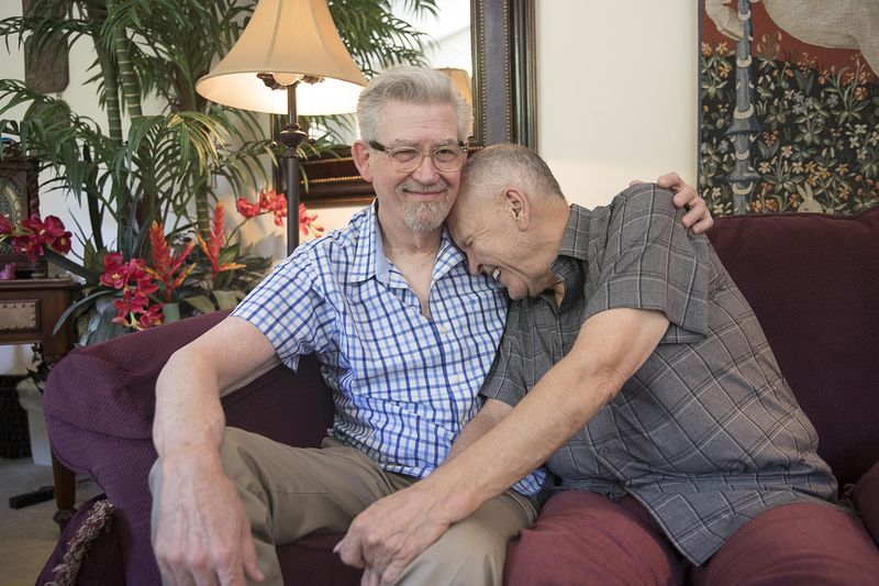 Charles Dillard (aka Mr. Charlie Brown, right) and Fred Wise (left) laugh while sitting for a photo at their residence in Austell, Wednesday, May 29, 2019. (Alyssa Pointer/alyssa.pointer@ajc.com)