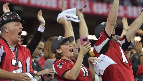 Falcons fans celebrate in the second half during the NFC divisional playoffs at the Georgia Dome on Saturday, January 14, 2017. The Falcons won 36-20 over the Seattle Seahawks. HYOSUB SHIN / HSHIN@AJC.COM