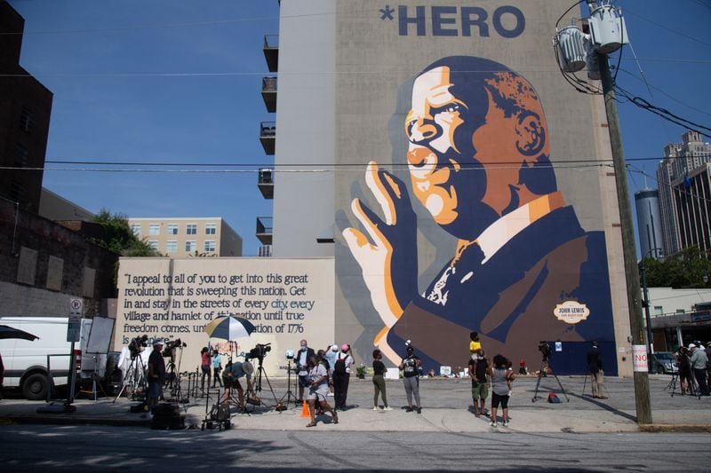 People gather in front of the large John Lewis mural on Auburn Ave, July 18, 2020.  STEVE SCHAEFER FOR THE ATLANTA JOURNAL-CONSTITUTION