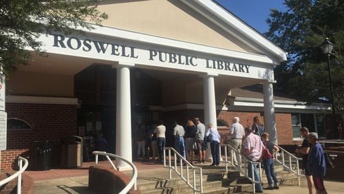 A line of residents participating in early voting snakes outside to the steps of the Roswell Public Library at Norcross Street on Monday, Oct. 17, 2016.