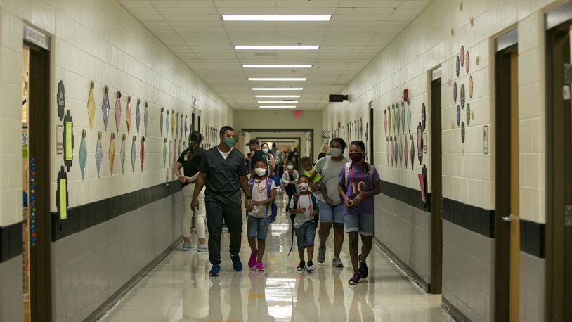 Students and parents walk through the halls on the first day of school at Clark Creek Elementary School in Acworth, Georgia, on August 2, 2021. (Rebecca Wright for the Atlanta Journal-Constitution)