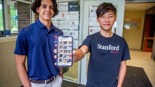 Atlanta International School seniors Rodrigo Villagomez (L) and George Song show their Instagram account called Futures of AIS 2021 witch lets fellow classmates know what college they've committed to. STEVE SCHAEFER FOR THE ATLANTA JOURNAL-CONSTITUTION