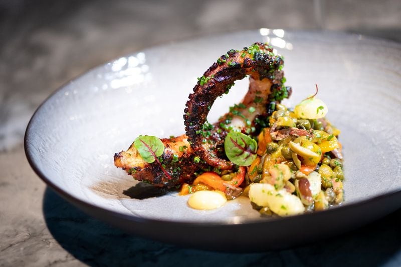 Charred Octopus appetizer with roasted red pepper, olives, capers, lemon, and olive oil. Photo credit- Mia Yakel.