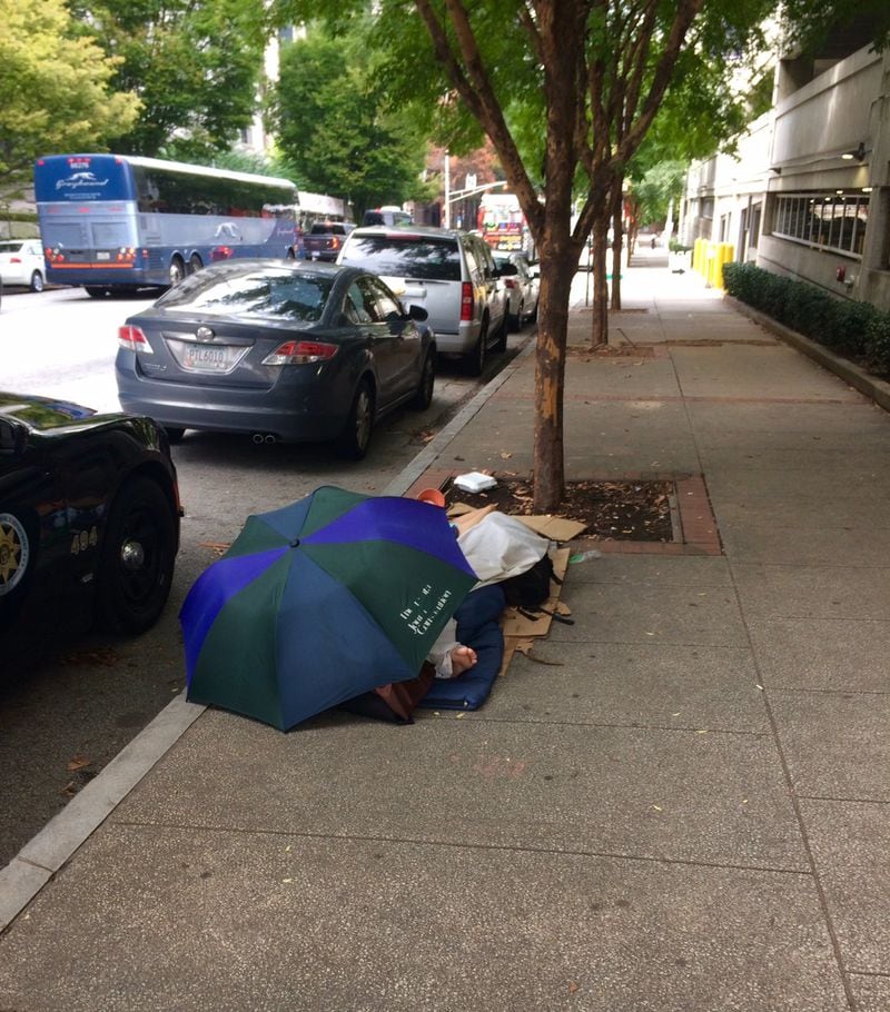 On Sept. 28, 2018, I was walking from the Fulton County Courthouse and saw Ricky Bradfield asleep in his normal spot. The AJC umbrella led me to shoot this picture. Two months later, Ricky was dead. 