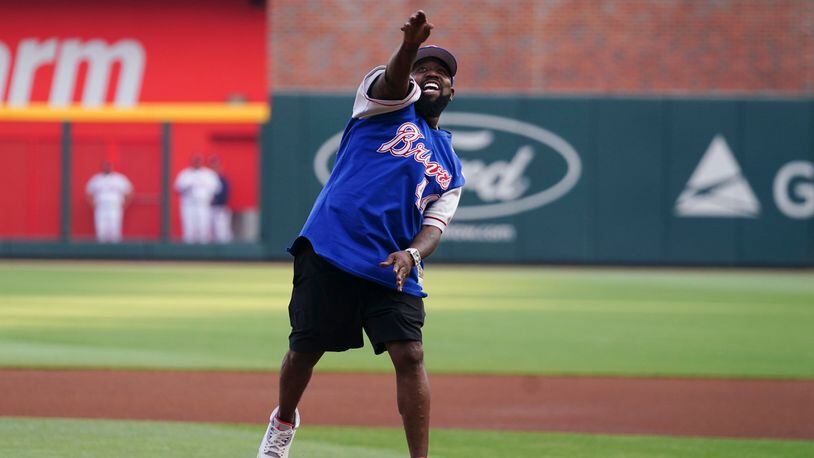 Big Boi, formerly of OutKast, throws out the ceremonial first pitch before a baseball game between the Atlanta Braves and the Philadelphia Phillies, Thursday, May 25, 2023, in Atlanta. (AP Photo/John Bazemore)