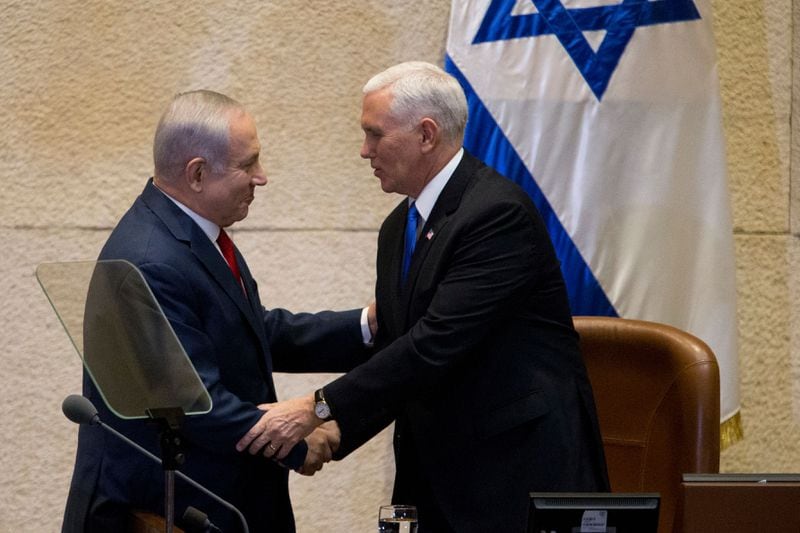 Israeli Prime Minister Benjamin Netanyahu, left, shakes hands with U.S. Vice President Mike Pence in Israel's Parliament.
