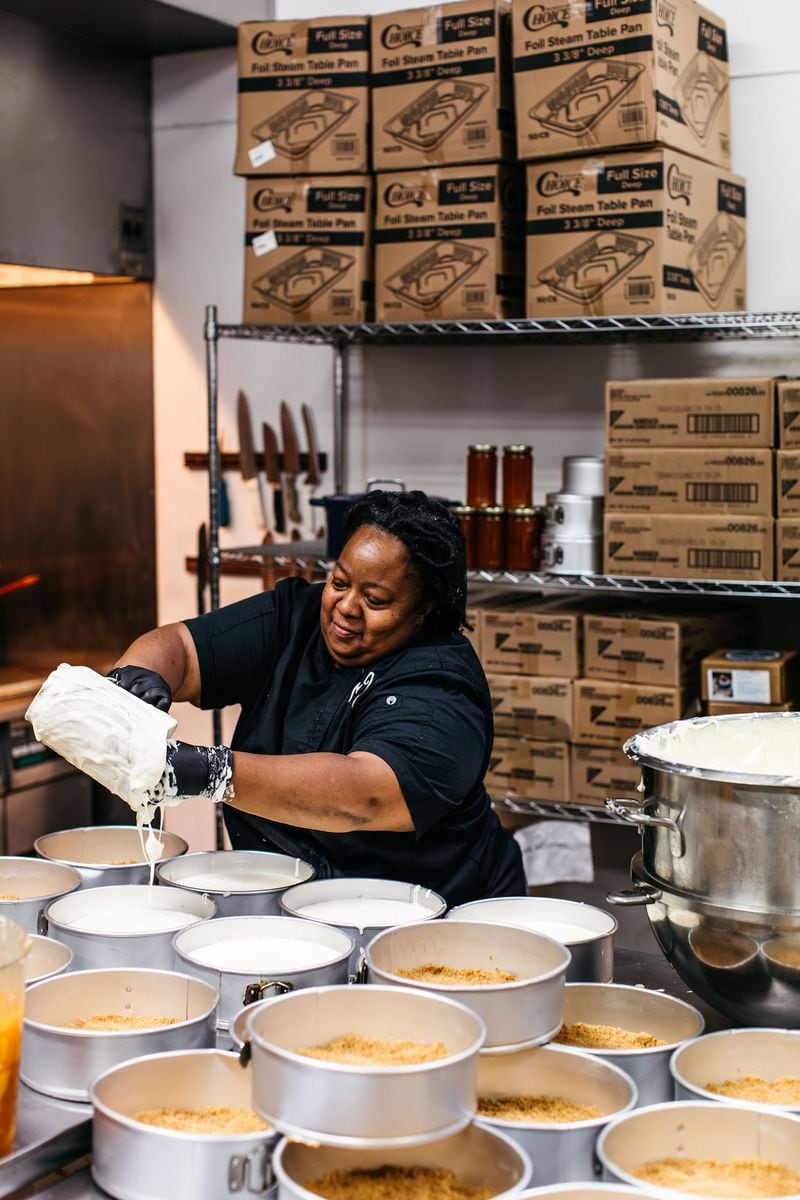 Nicole Herrington pours the fillings for some of the 90 to 120 cheesecakes that the Honey Cheesecakes team bakes each day. Courtesy of Megan Baradine