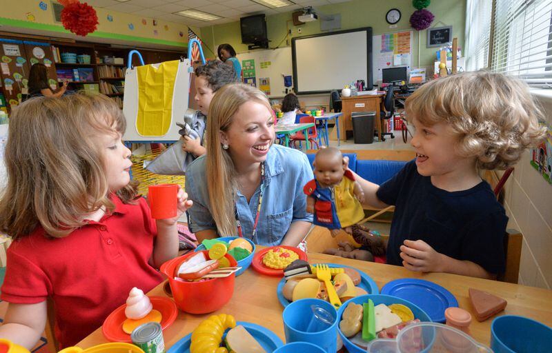 September 10, 2014 Atlanta - Pre-Kindergarten teacher Erin Augustine (center) works with her students Savannah Thelen (left), 4, and Kingston Rogers, 4, at Montgomery Elementary School on Wednesday, September 10, 2014. Education has emerged as one of the key issues in the gubernatorial race, with both candidates promising changes aimed at improving student achievement. Among the education topics being debated is Pre-Kindergarten. HYOSUB SHIN / HSHIN@AJC.COM There is a debate underway among parents about when children should start "academic" school. and whether preschool is too soon. A new study will likely add to the debate. HYOSUB SHIN / HSHIN@AJC.COM