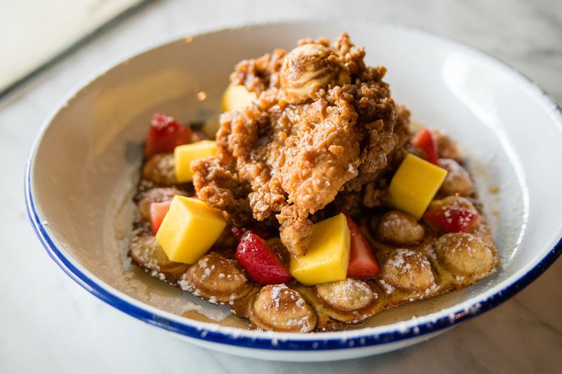 An Atlanta classic with an Asian twist: fried chicken with a bubble waffle at Whiskey Bird in Morningside. CONTRIBUTED BY HENRI HOLLIS