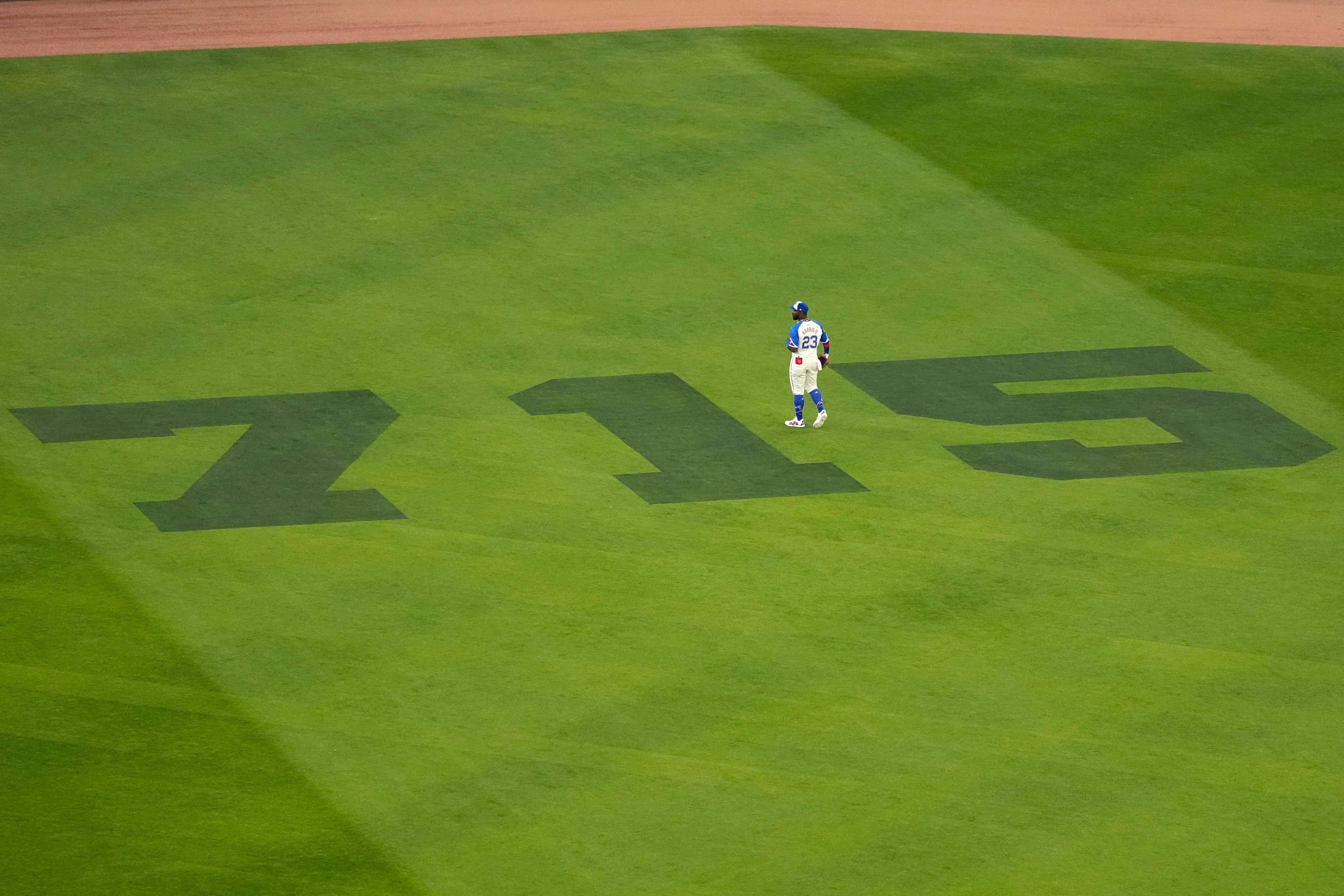Atlanta Braves center fielder Michael Harris II walks on the outfield painted with 715 to mark the 50th anniversary of Hank Aaron breaking Babe Ruth's home run record before a baseball game against the New York Mets Monday, April 8, 2024, in Atlanta. (AP Photo/John Bazemore)
