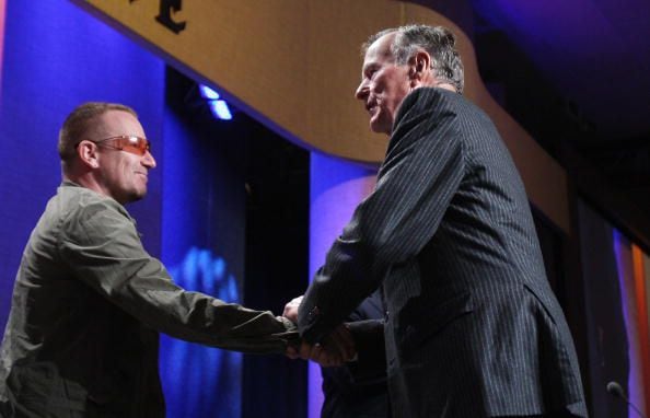 2008: Former U.S. President George H.W. Bush (R) shakes hands with musician Bono