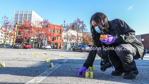 Atlanta police crime scene technician K. Gallagher collected more than 30 shell casings in the parking lot across from the Monaco Hookah Lounge.