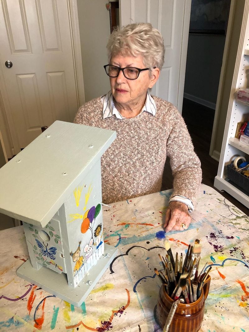 Judy Coffee works on painting a birdhouse for the Totem Pole Garden at Avondale Elementary School. Courtesy of Carolyn Chandler