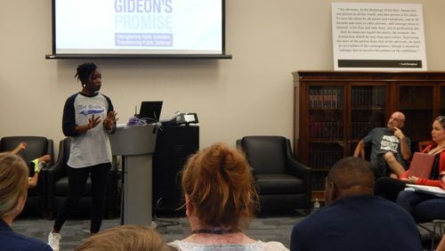 Ilham Askia (standing left) introduces herself to the Gideon’s Promise Class of 2016 by telling her story at the Summer Institute last year while her husband, Jonathan Rapping (right), listens. Askia left her job as a first-grade teacher to help her husband run the nonprofit. CONTRIBUTED BY GIDEON’S PROMISE