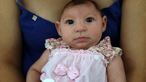 Maria Carolina Silva Floa, 20, holds her baby, Maria Gabriela Silva Alves, 2 months, who was born with microcephaly, as they wait for her physiotherapy appointment at Pedro 1 Municipal Hospital in Campina Grande, Brazil. (Katie Falkenberg/Los Angeles Times/TNS)