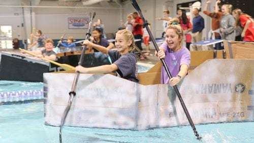 Students at Simpson Middle School test the Cardboard Regatta, which required students to use STEAM components to design the boats.
