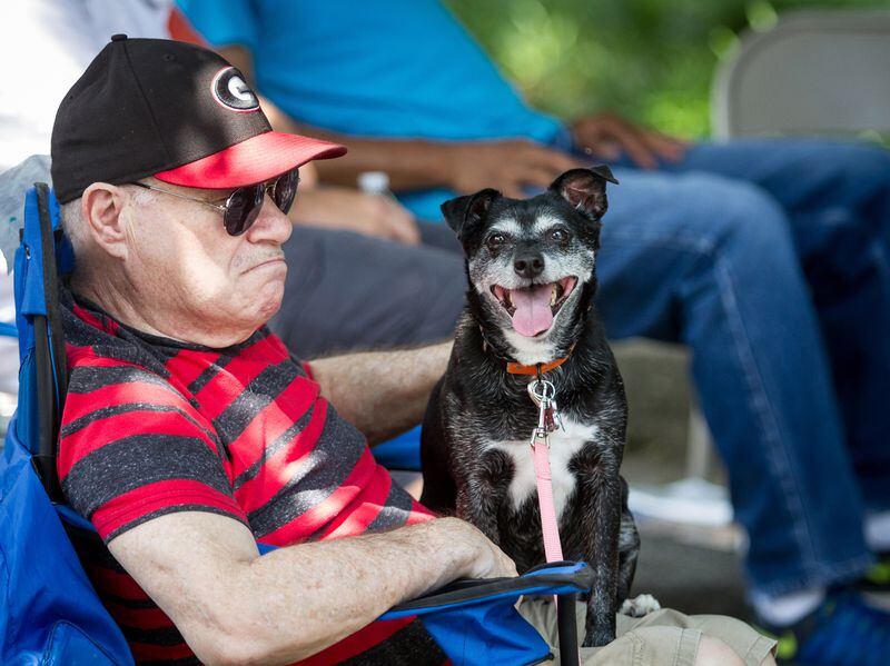 Marrin Mednik pets his friend's dog Glavin during the Bluesberry & Beer Festival in Norcross, Ga., on Saturday, June 16, 2018.  STEVE SCHAEFER / SPECIAL TO THE AJC