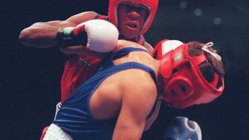 Floyd Mayweather (rear) of the U.S. boxing team, mixes it up with Artur Gevorgyan of Armenia during their boxing match at Alexander Memorial Coliseum at Georgia Tech during the 1996 Summer Olympic Games in Atlanta on Saturday, July 27, 1996. Mayweather went on to win the fight. (AP Photo/Rick Bowmer)
