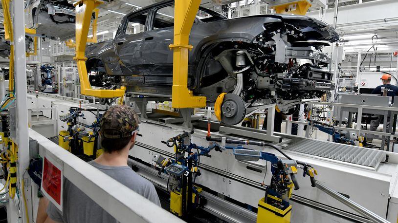 Manufacturing workers assemble the R1T electric vehicle at Rivian in Normal, Ill., on July 20, 2022. (Photo for the Atlanta Journal Constitution by Ron Johnson)