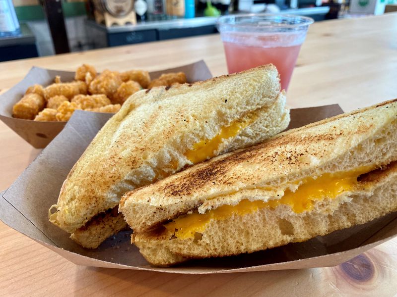 The Abby Singer’s grilled cheese is a bit ho-hum. It is pictured here with tater tots and a Cranberry Margarita.
Wendell Brock for The Atlanta Journal-Constitution