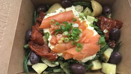 The star of the Ole Reliable lunch menu is the smoked salmon salad niçoise, a feel-good mélange of potatoes, green beans, kalamata olives, preserved tomatoes and cucumber, with a layer of egg salad and smoked salmon rolls garnished with scallions. LIGAYA FIGUERAS / LFIGUERAS@AJC.COM.