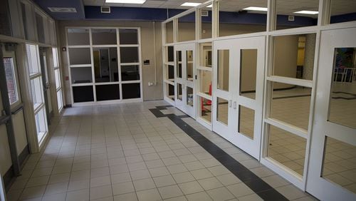 A new security feature, an extra set of doors and a check-in window, are under construction at Johns Creek Elementary School in Suwanee. (ALYSSA POINTER/ALYSSA.POINTER@AJC.COM)