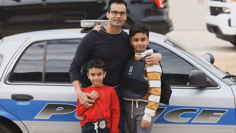 Henry County police Officer Paramhans Desai with his two sons, 11-year-old Om and 8-year-old Namah.