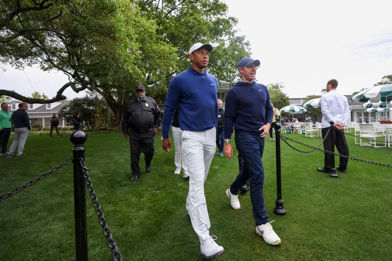 Tiger Woods, left, and Rory McIlroy talk as leave the clubhouse on their way to the tenth tee to start their practice round for the 2023 Masters Tournament at Augusta National Golf Club, Monday, April 3, 2023, in Augusta, Ga. Jason Getz / Jason.Getz@ajc.com)
