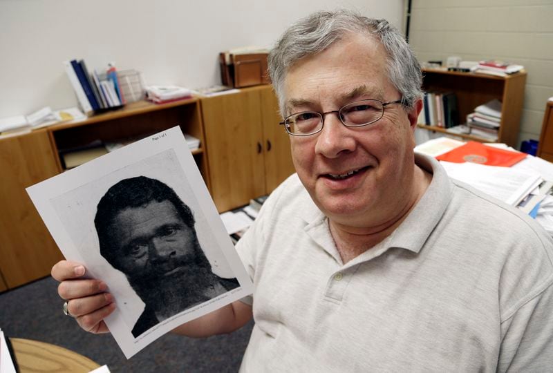 In this Wednesday, June 27, 2012 photo, Roy Finkenbine, University of Detroit Mercy History Professor and Interim Dean, College of Liberal Arts and Education, holds a print showing Jordan Anderson, in his office in Detroit. Finkenbine is planning a biography of the former slave who is credited with writing a remarkable letter to his ex-master. (AP Photo/Paul Sancya)