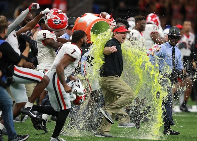 January 1, 2020 New Orleans: Georgia head coach Kirby Smart gets dunked rushing the field with tailback D’Andre Swift and teammates beating Baylor 26-14 to win the Sugar Bowl NCAA college football game at the Superdome on Wednesday, January 1, 2020, in New Orleans.  Curtis Compton ccompton@ajc.com