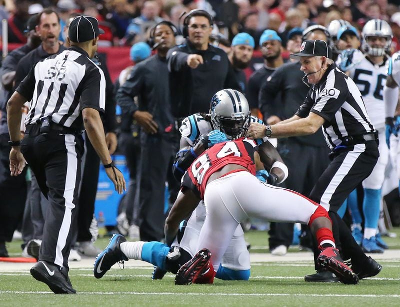  122815 ATLANTA: Officials seperate Falcons wide reciever Roddy White and Panthers cornerback Charles Tillman as they get into a tussle after White made a reception during the first quarter in a football game on Sunday, Dec. 27, 2015, in Atlanta. Looking on is Panthers head coach Ron Rivera. Curtis Compton / ccompton@ajc.com