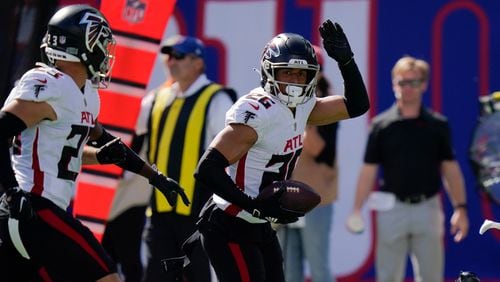 Falcons cornerback Isaiah Oliver (right) won't be rushed back after knee surgery, coach Arthur Smith said. (Seth Wenig/AP)