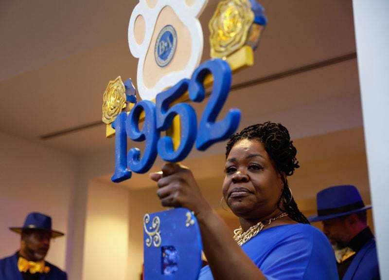 Versha Patrick, a member of the last line of Sigma Gamma Rho Sorority Inc. at Morris Brown holds a staff during the coming out ceremony of the first line at the college in more than 20 years on Friday, March 22, 2024.  (Natrice Miller/ Natrice.miller@ajc.com)